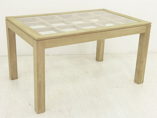 Dining table with glass top on an elegant lattice